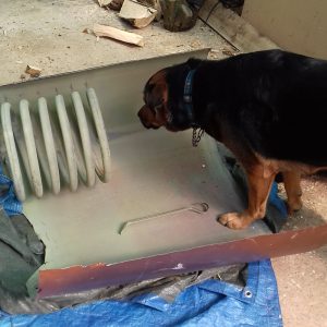 Waste not want not: I use salvaged copper in my copper work. Picture of my dog Manali inspecting an old copper tank as it was being cut down to a workable size
